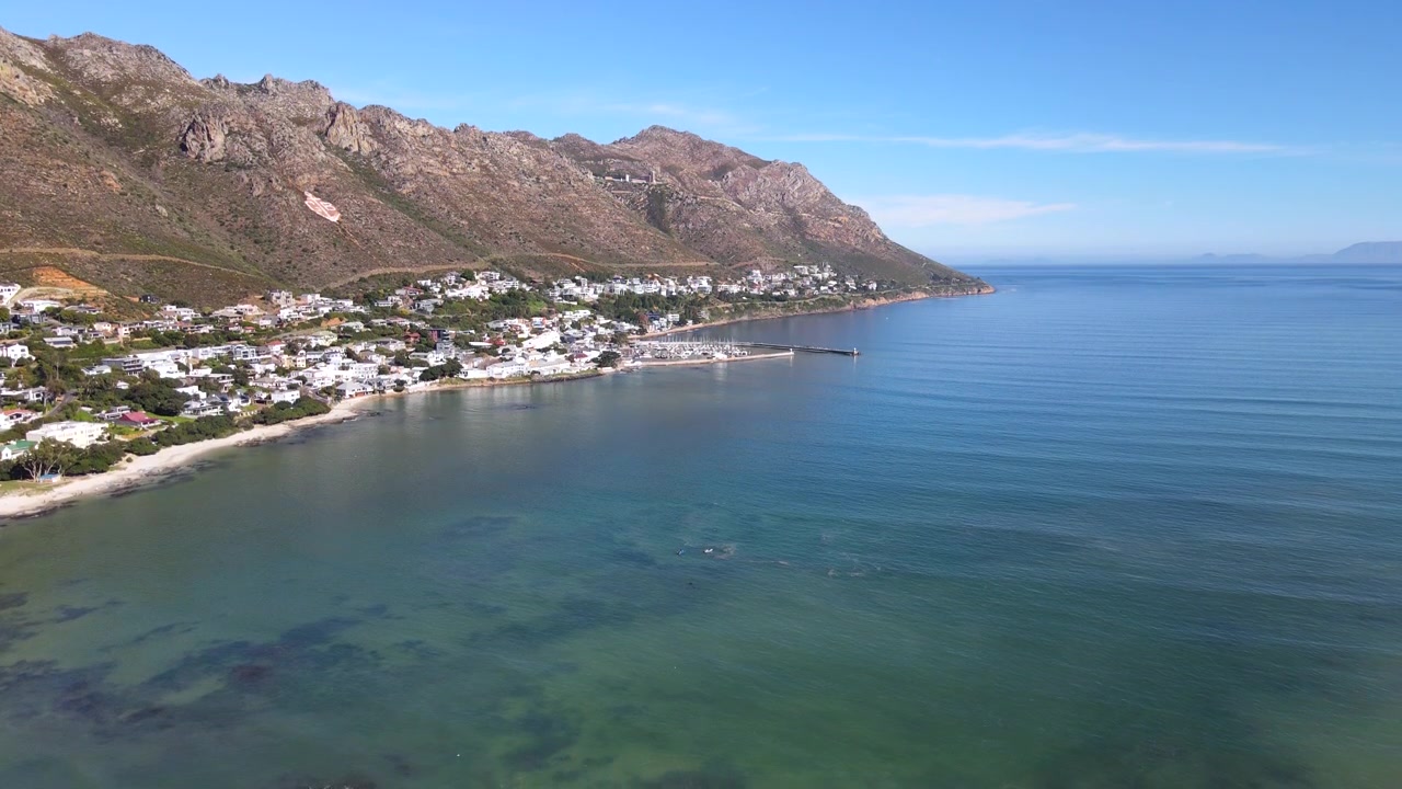 Gordon's Bay coastal town below mountain and next to Clarence Drive route. Drone