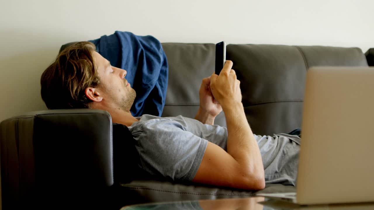 Man using mobile phone in living room 4k
