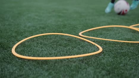 a children's football team trains at the stadium under the guidance of a coach. kids in sports uniforms practice ball exercises, improve technique, and develop teamwork on the green field