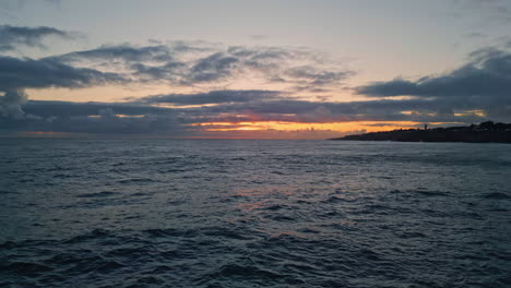 amazing golden skyline ocean water rippling. aerial sunset light shining horizon