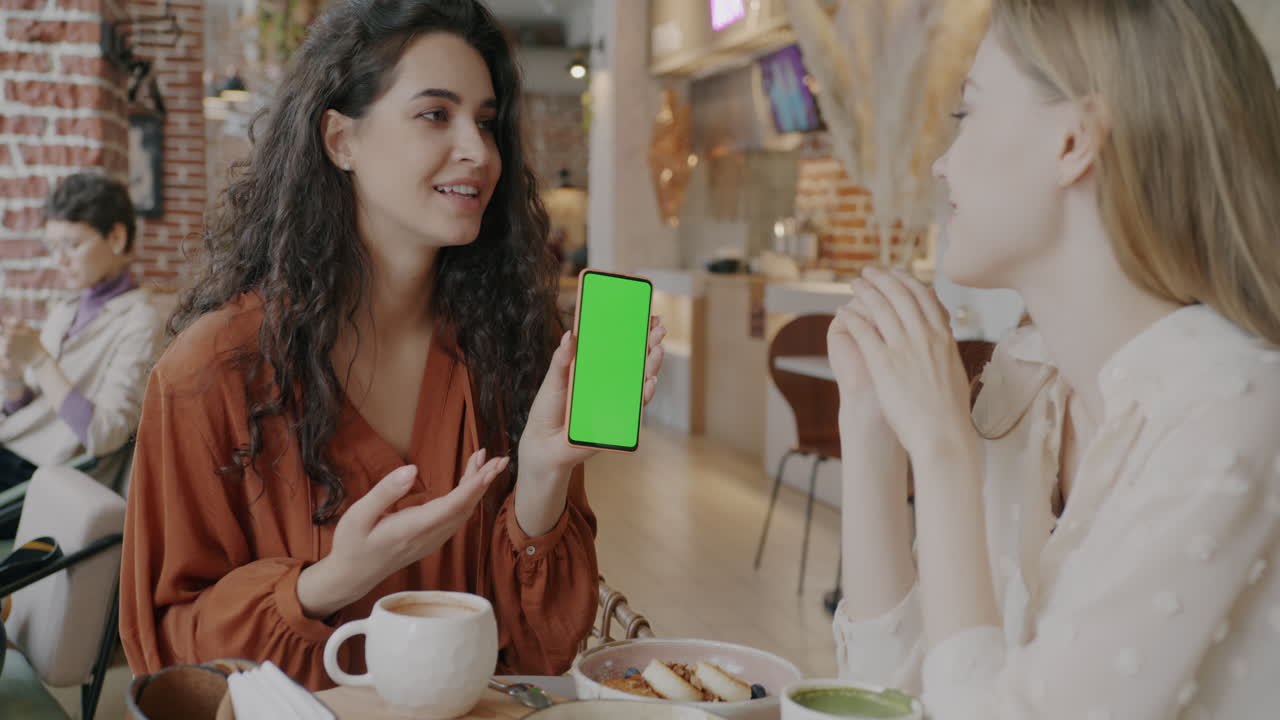 Two Women Friends Having Conversation in a Cafe
