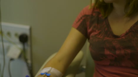 iv drip being connected and tilting up to young woman in hospital