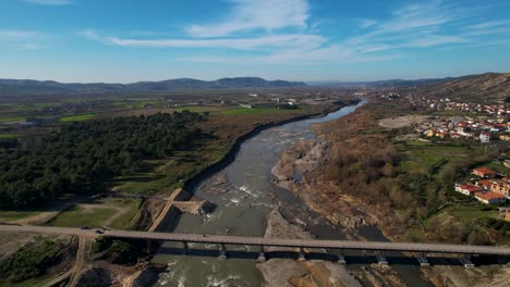 Bridge-over-Shkumbin-River-in-Albania,-the-riverbed-damaged-from-erosion-and-sand-mining