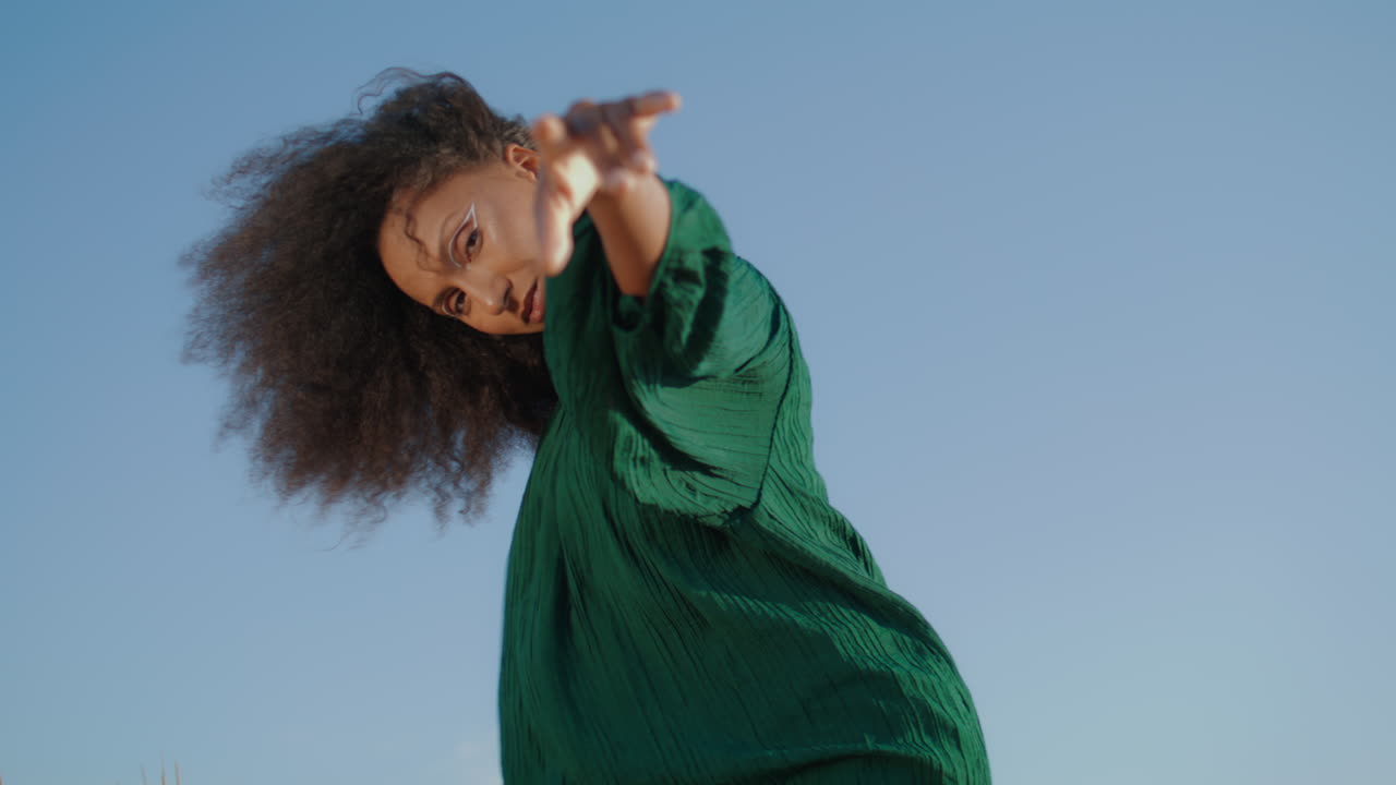 Graceful girl dancing nature in front gray sky close up. Woman dancing sensually