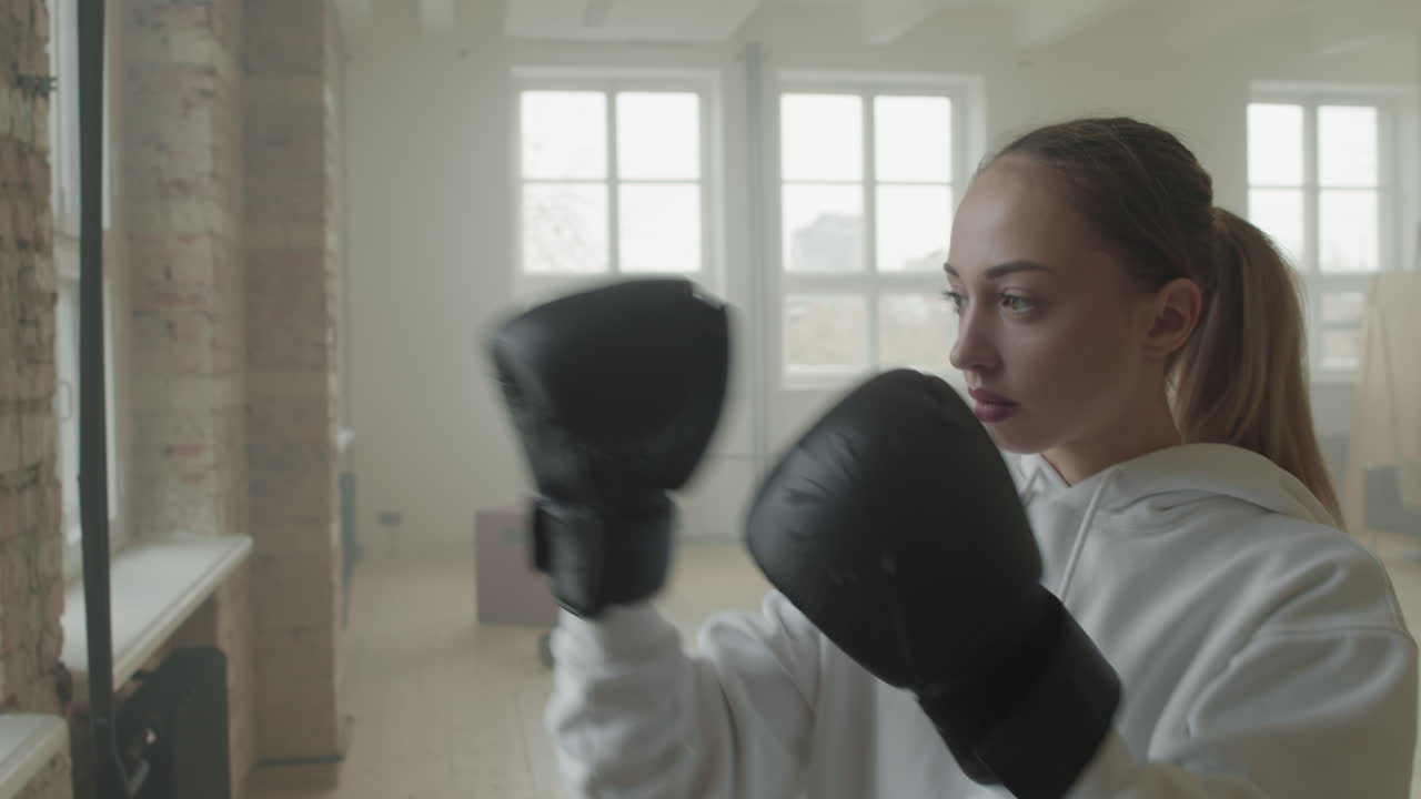 Athletic Woman Putting On Boxing Gloves