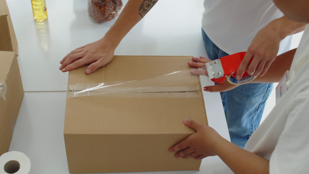 Volunteers Team Preparing Donation Boxes for Homeless People