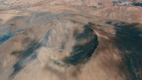 gairia volcanic caldera: aerial shot over the crater of the volcanic caldera on a sunny day with beautiful orange colors