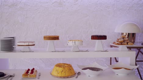 assorted cakes on elegant display stands for a dessert buffet setup