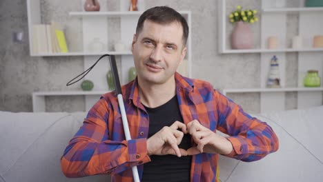 Happy-blind-man-making-heart-sign-at-camera.