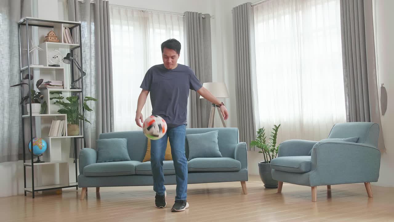 Asian Man Show Skill With Soccer Ball In Living Room, Soccer Freestyle