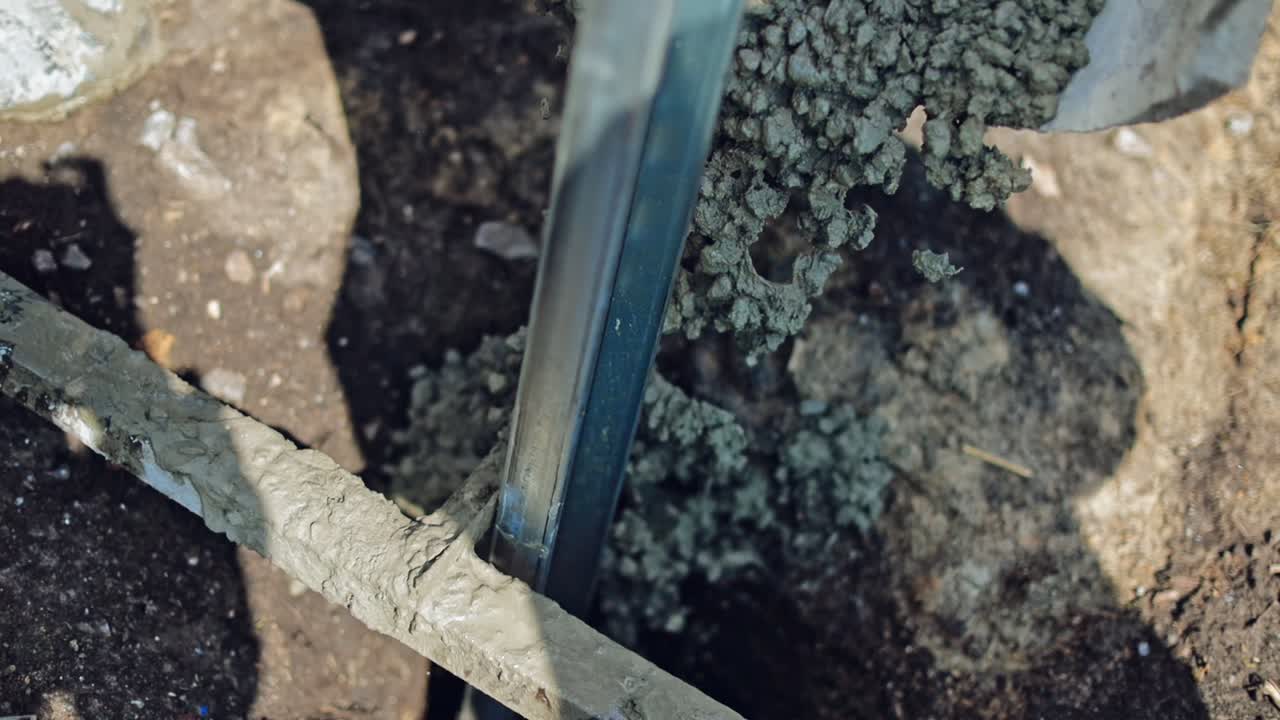 Metal basis for solar panel on the construction site. Ready cement is pouring out to fix metal frame. Close-up.
