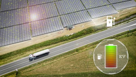 Eco-friendly-electric-truck-charging-on-solar-field-with-battery-indicator-and-charger