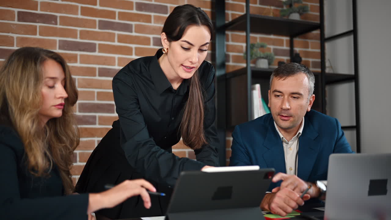 Woman making a presentation to her coworkers in an office