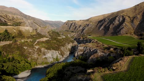 aerial pull back of kuwaru river canyon, vineyard sits on rocky edge