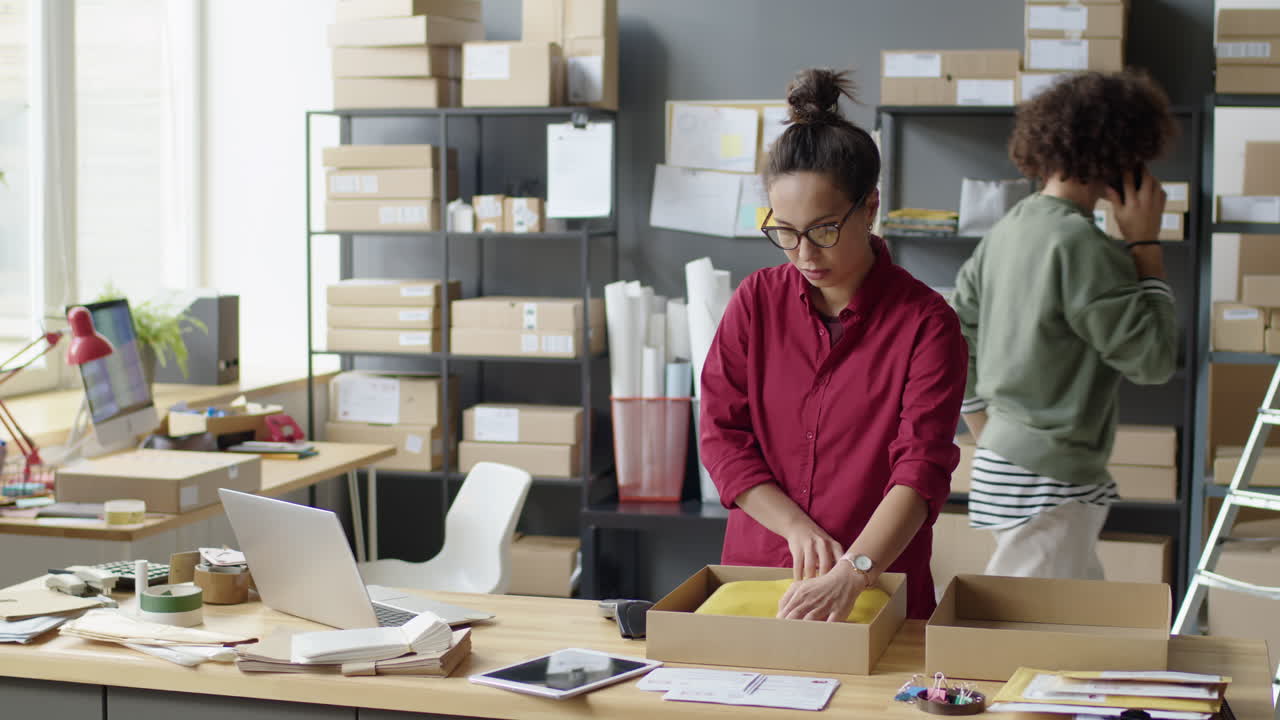 People packaging orders in a small business office