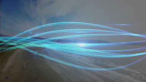 blue light trails forming animation over coastal landscape at night