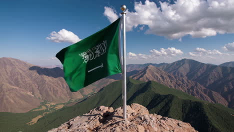 saudi arabia flag on mountain peak