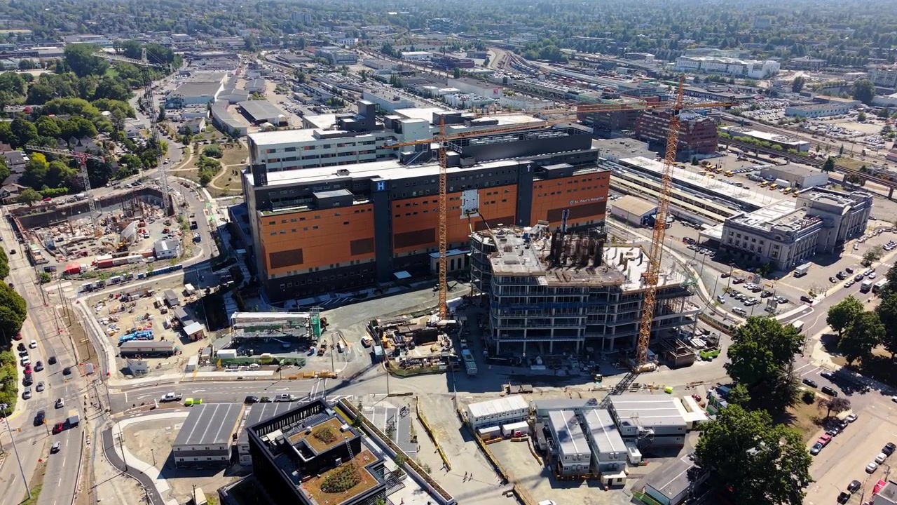 New St. Paul's Hospital Construction Site With Cranes And Heavy Machinery In Vancouver, British Columbia, Canada. - aerial shot