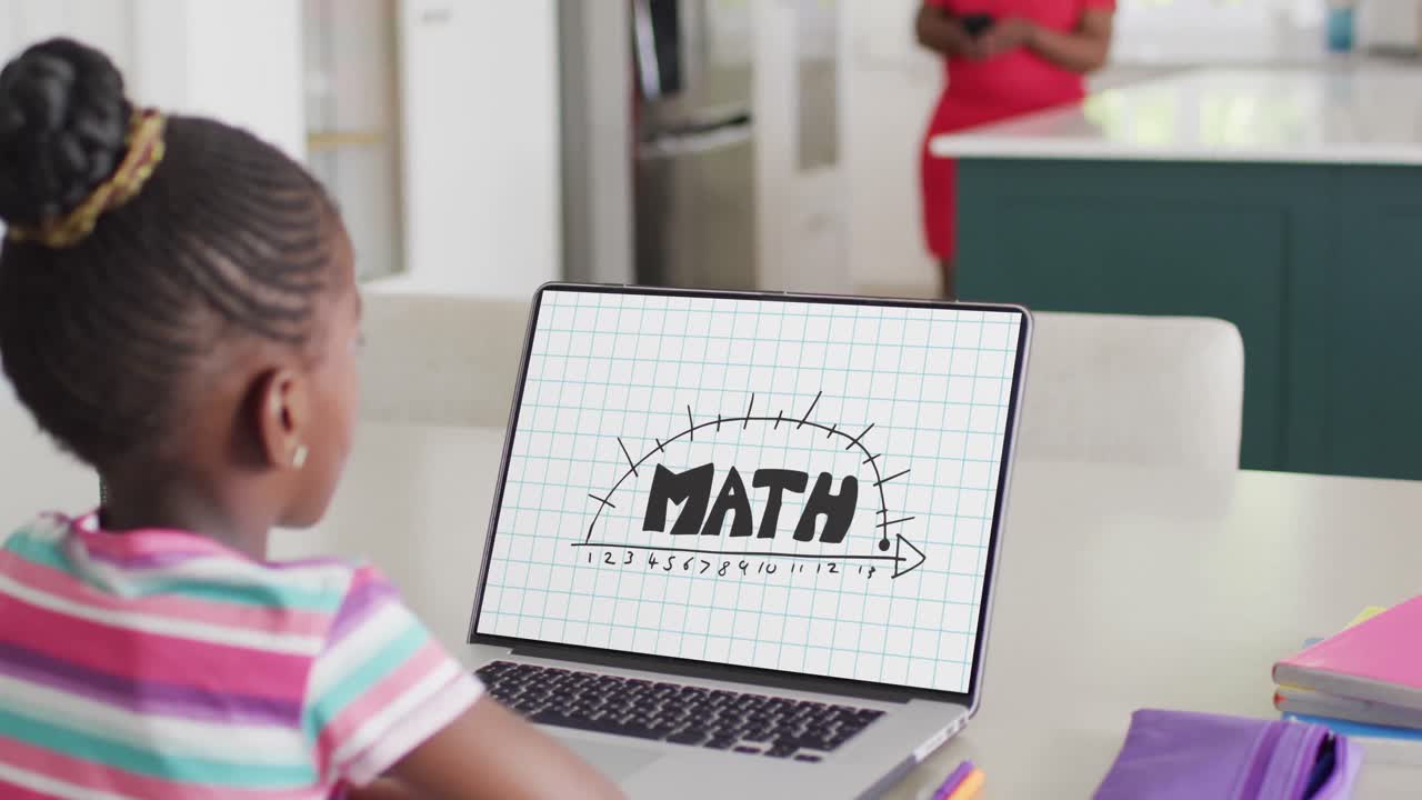 African american girl using laptop with math text on screen