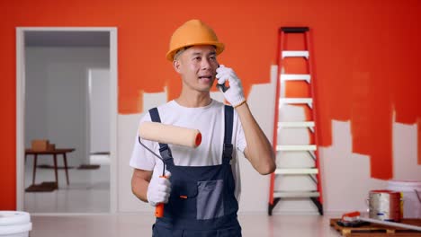ein maler telefoniert während einer renovierung des hauses