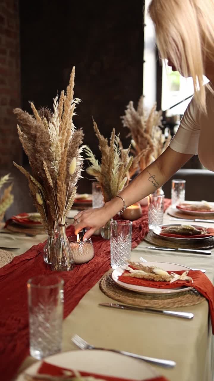 Woman Lighting Candles on a Beautifully Decorated Dining Table