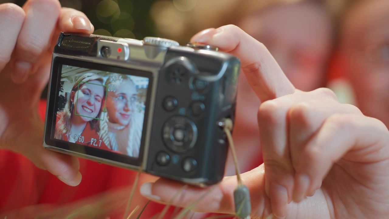 Hands Holding Digital Camera Taking Selfie of Two Happy Women