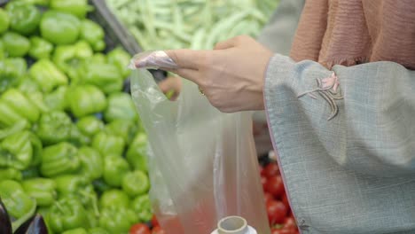 woman buying vegetables at a grocery store