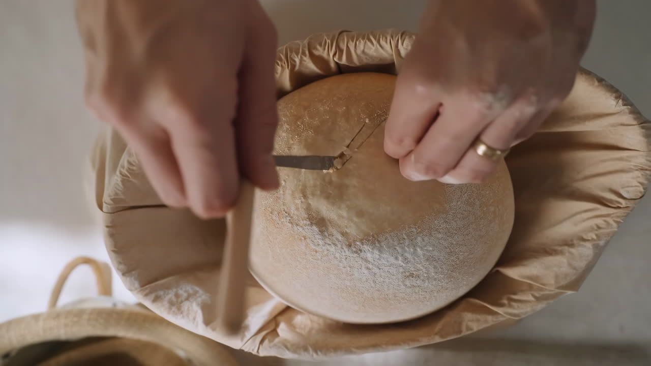 Hands Scoring Sourdough Bread Dough