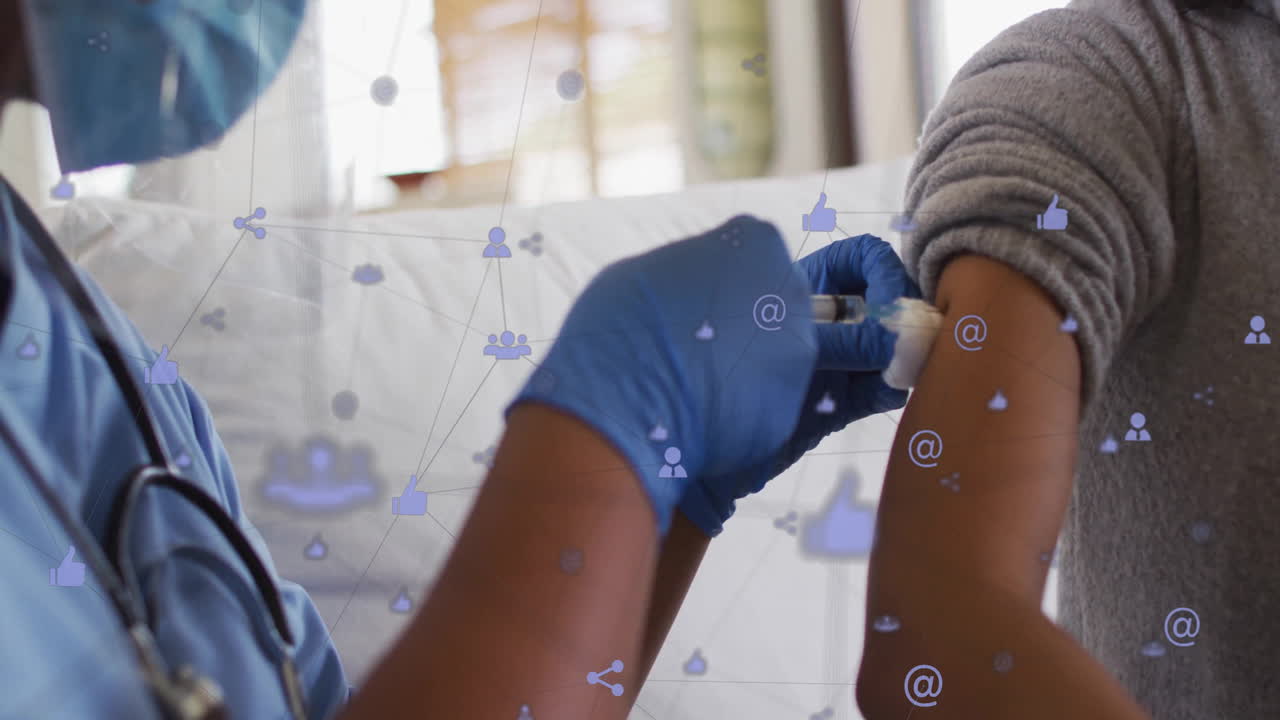 Animation of network of connections with icons over african american female doctor and patient