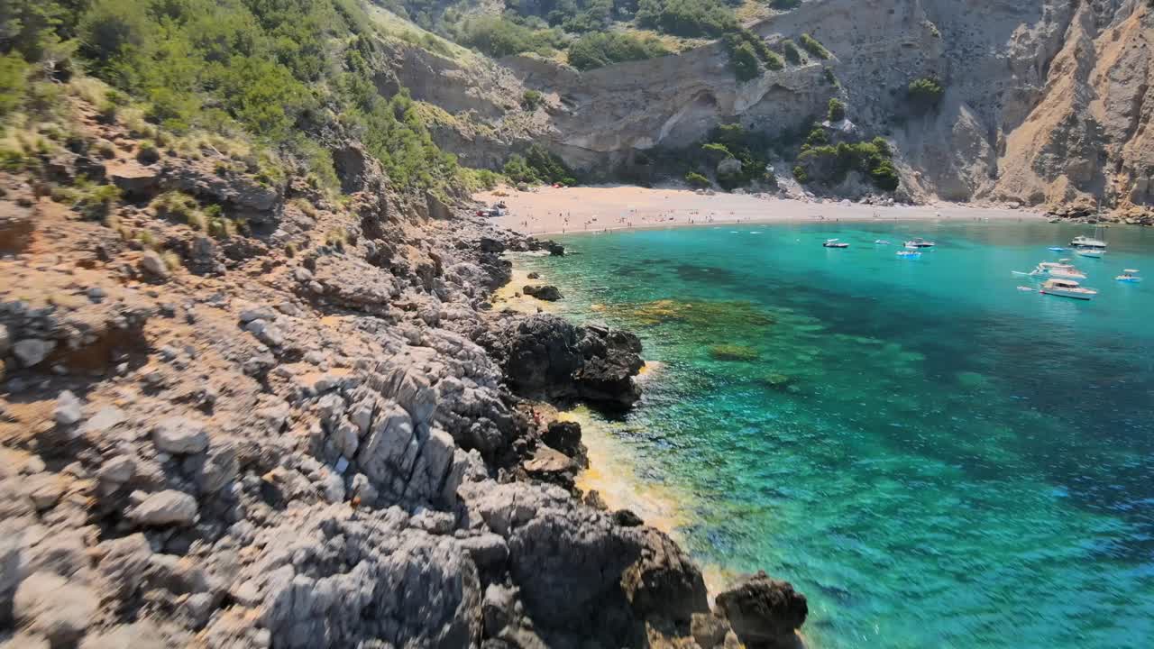 Experience the breathtaking views of Coll Baix beach near Puerto de Alcudia. Enjoy crystal-clear waters, rocky shores, and a peaceful atmosphere perfect for relaxation and adventure.