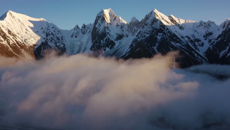 majestic snow-capped mountains emerging from clouds