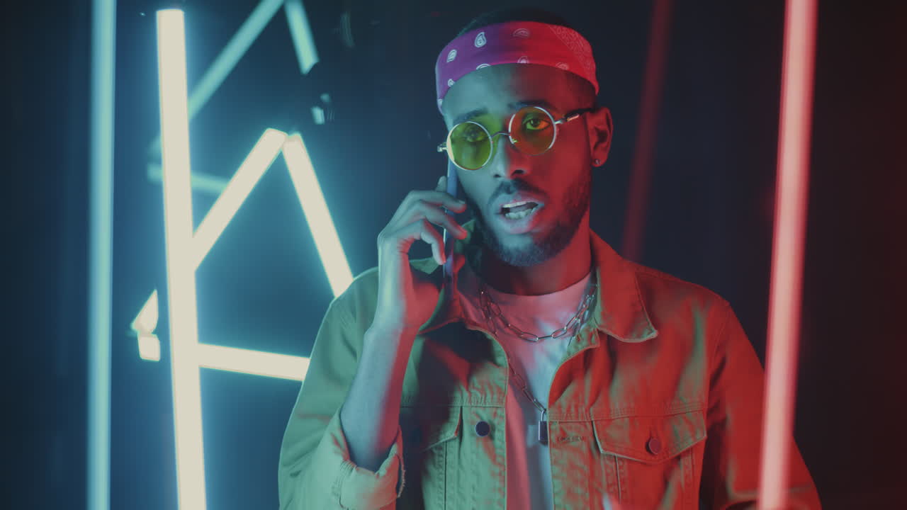 Stylish Man on a Phone Call in Neon Light