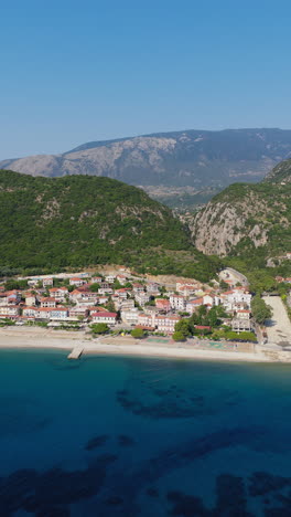 poros town surrounded by mountains and sea, kefalonia island, ionian sea, aerial vertical shot, establishing