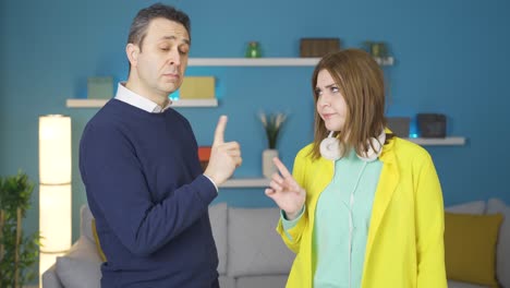 The-father-warns-his-daughter,-and-the-daughter-warns-her-father-with-a-finger.-Cute-image.