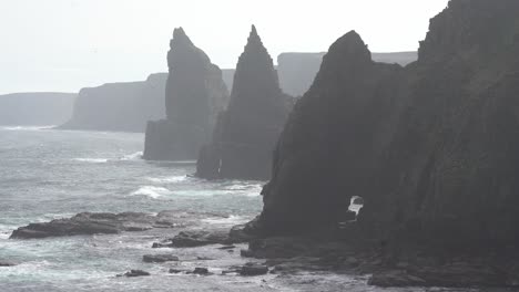 Duncansby-Stacks-majestic-rock-formations-surrounded-by-the-rhythmic-waves-of-the-Scottish-ocean