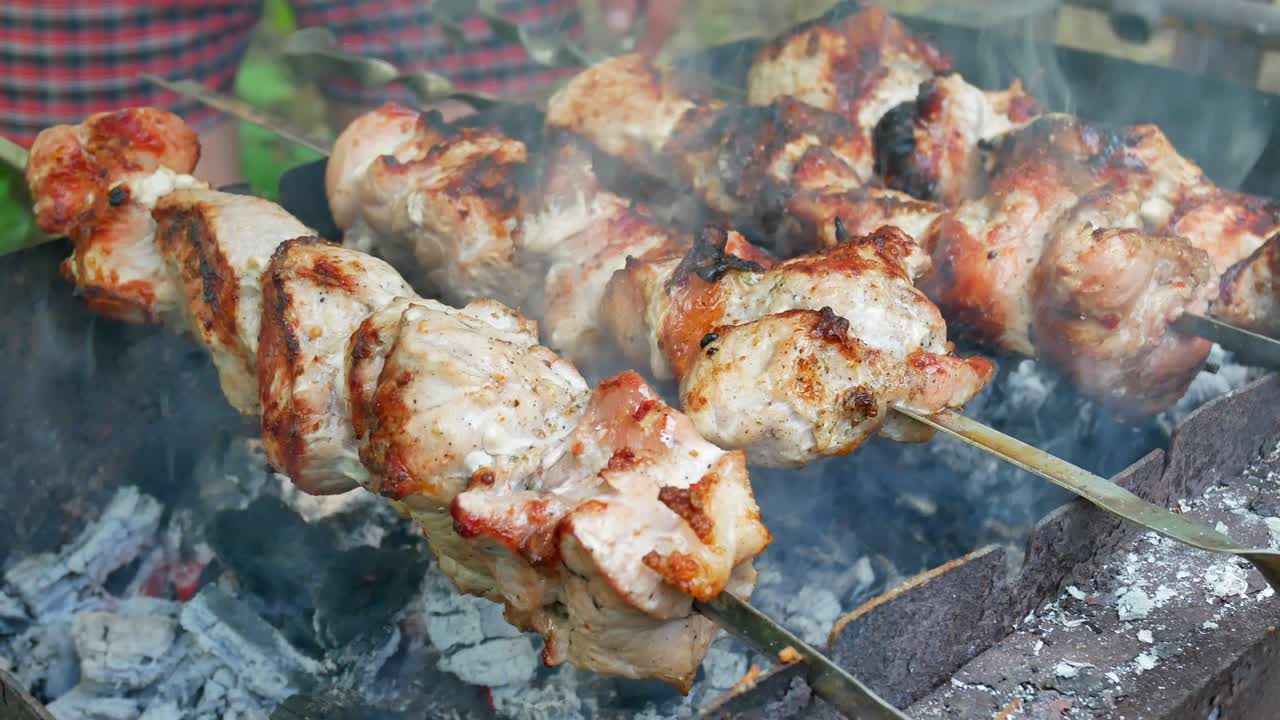 Pork steaks on the grill with flames and smoke