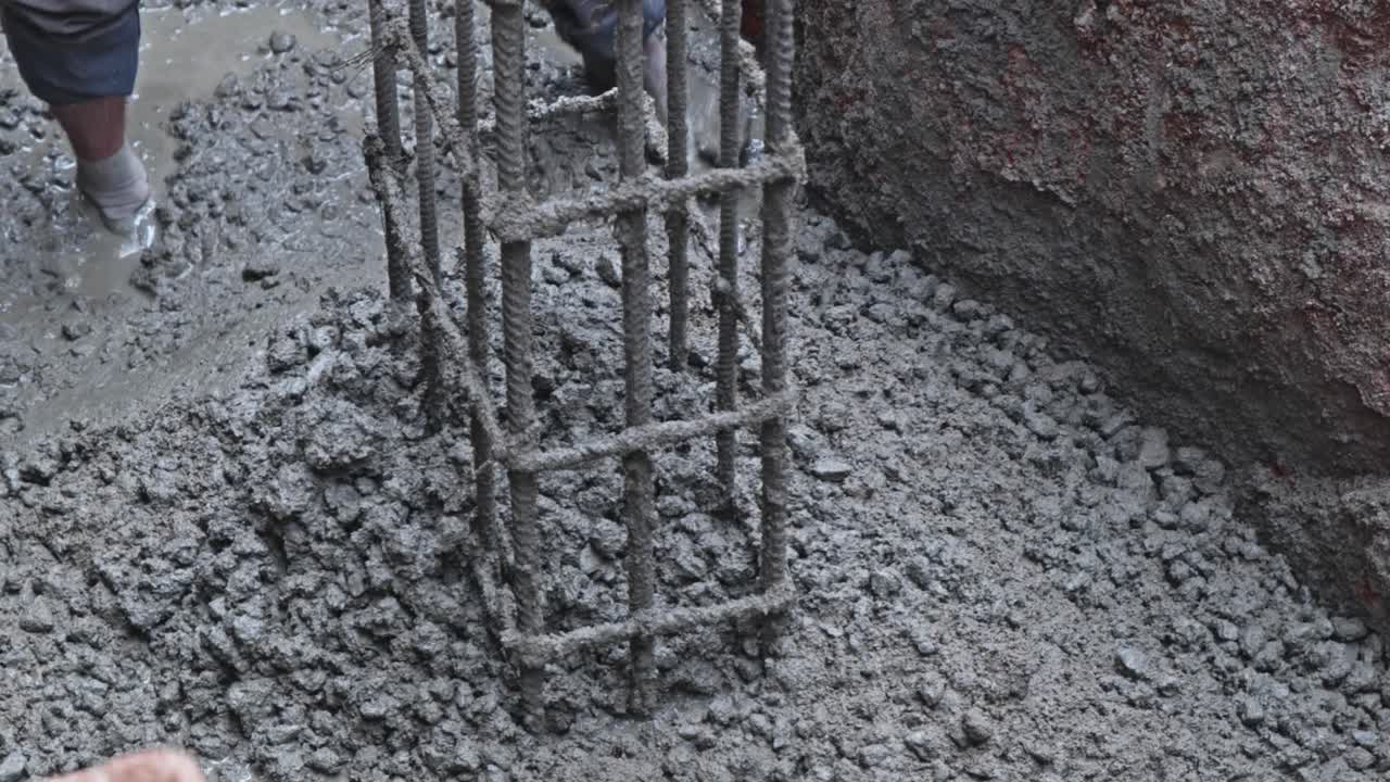 Construction Workers using trowel tool for Leveling Concrete at Footing Foundation. day time, zoom out shot, 4k