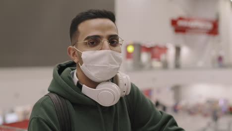 closeup of man in headphones in airport
