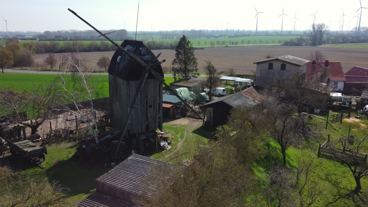 Old Abandoned Wooden Windmill in Rural Landscape