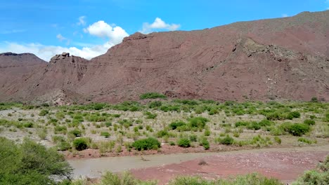 beautiful mountainscape and a river in cafayate valley at route 68 on a sunny day