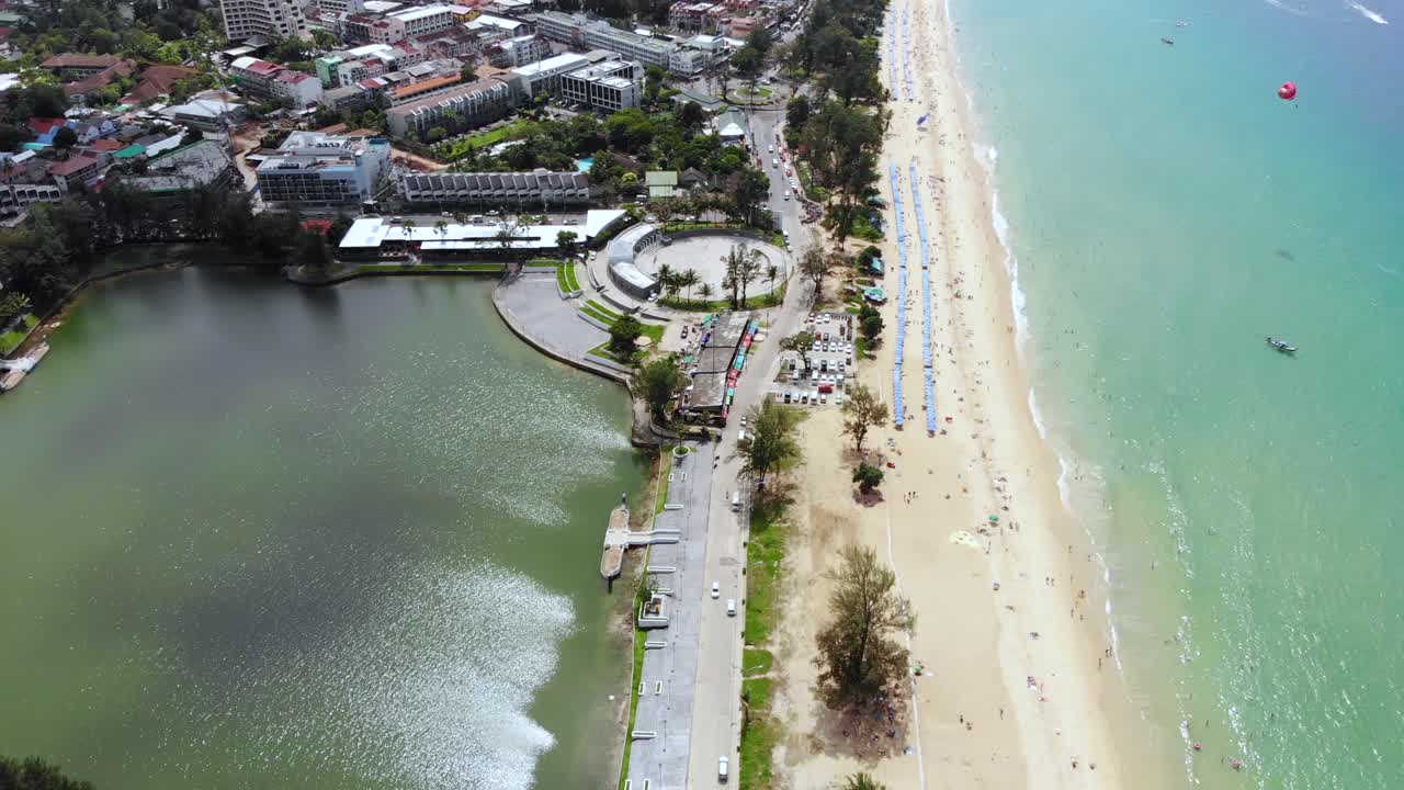 Aerial Pedestal Above Nai Harn Beach And Nai Harn Lake. Follow Shot