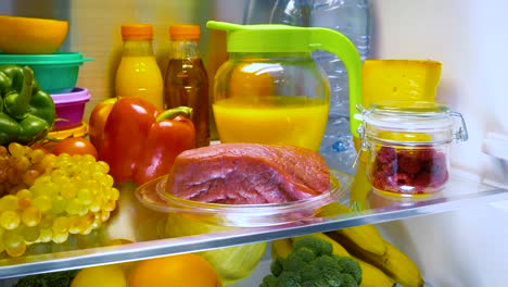 fresh raw meat on a shelf open refrigerator