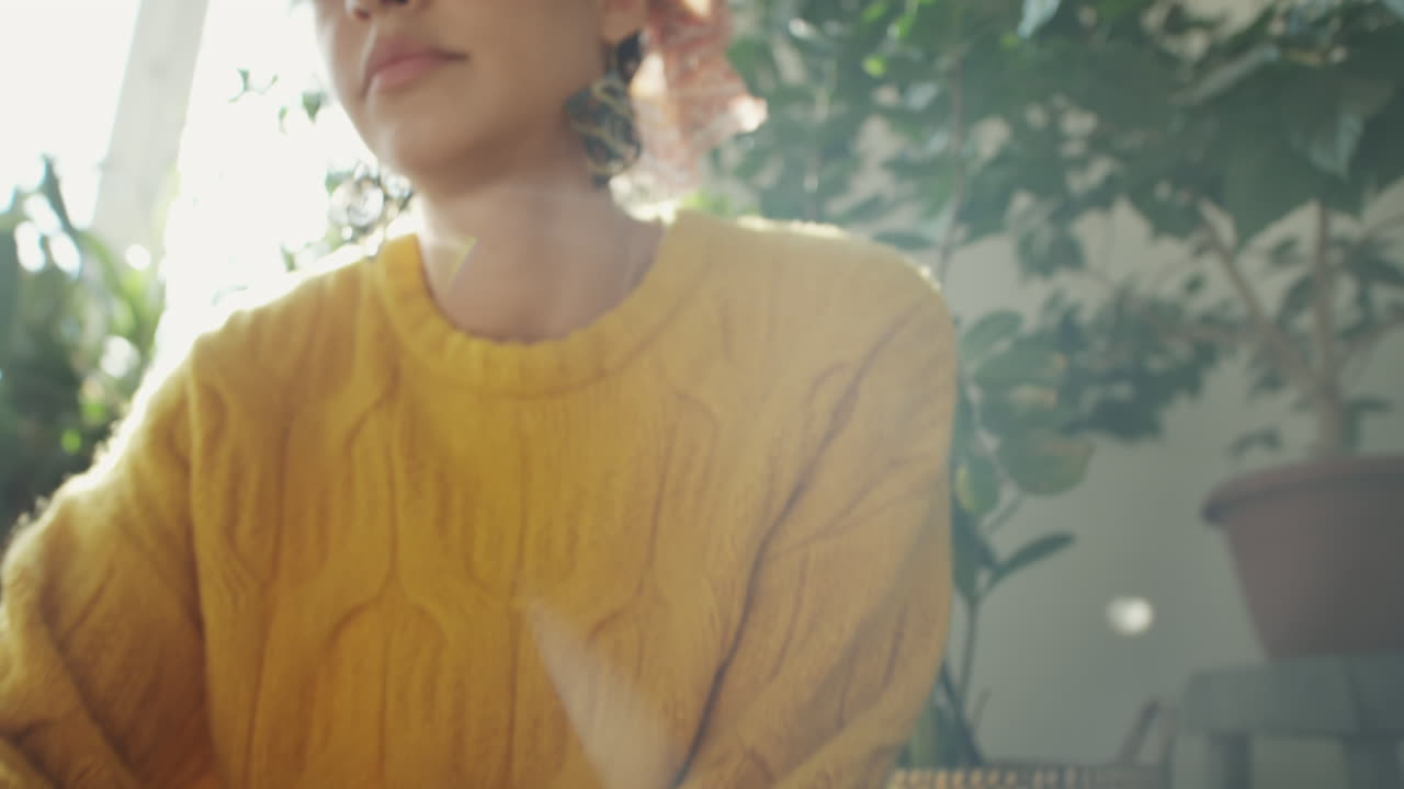 Woman Repotting Plants at Home