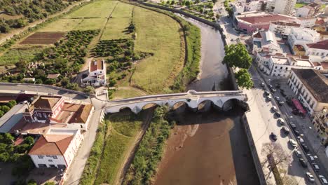 slow flyover of the historic arch bridge in silves, portugal