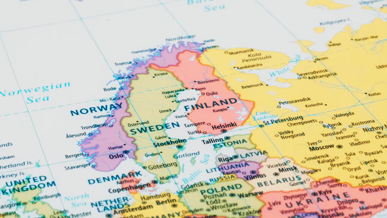 Close-up of the country word Finland on a world map with the detailed name of the capital city