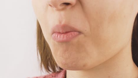 woman eating cashew in close-up. nuts.