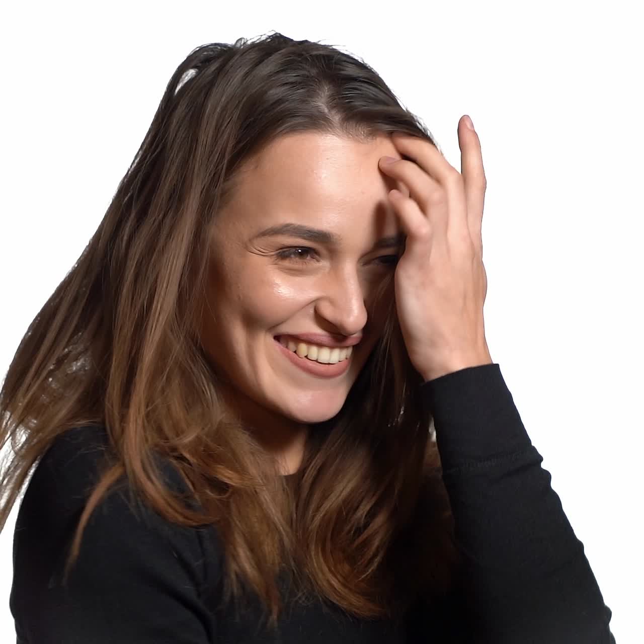 Smiling cute girl combing hair