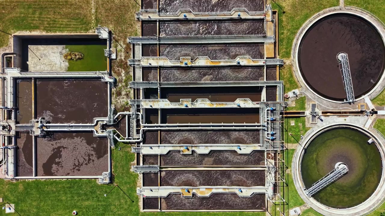 Water treatment facility processes waste material and cleans water for community use during sunny day