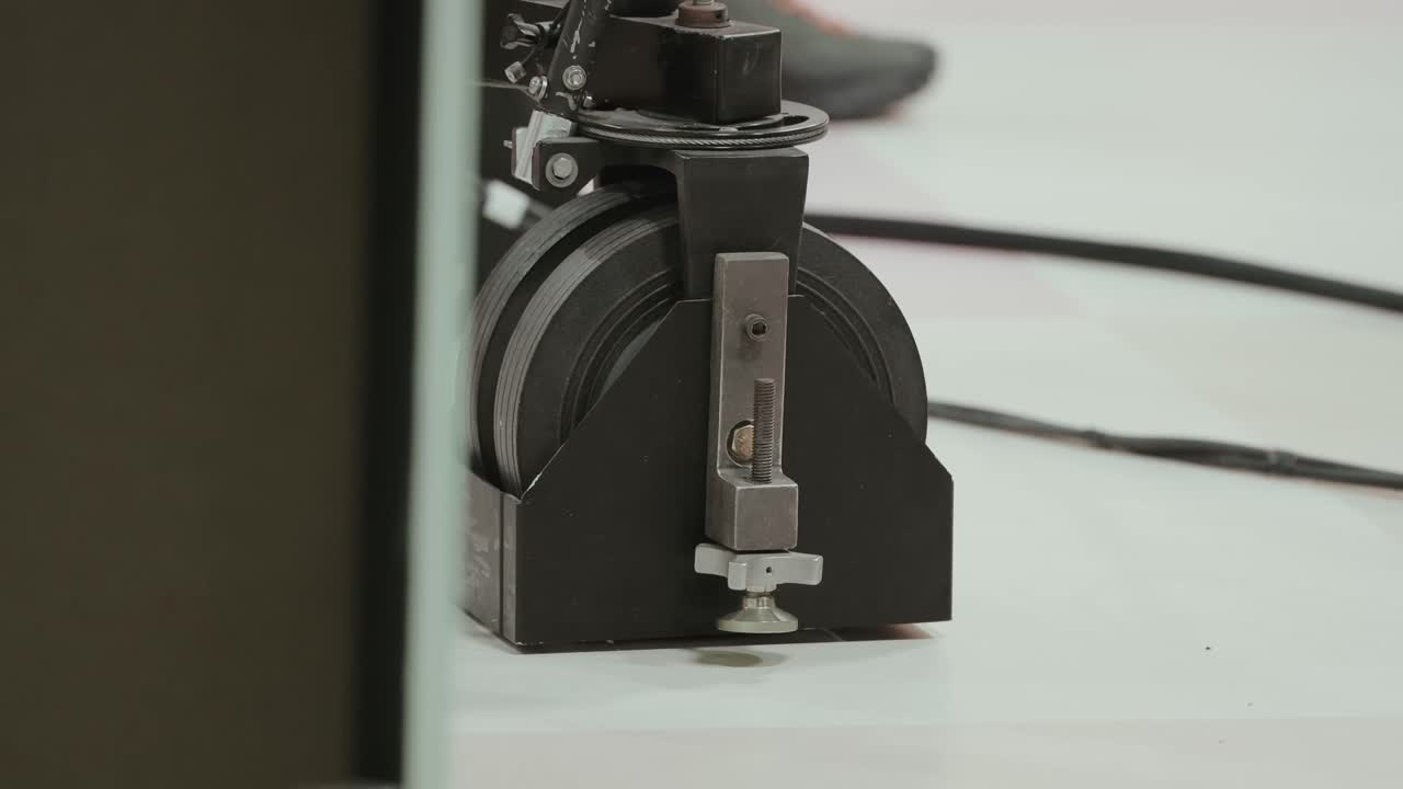 Close up of camera dolly wheel assembly on studio floor during setup