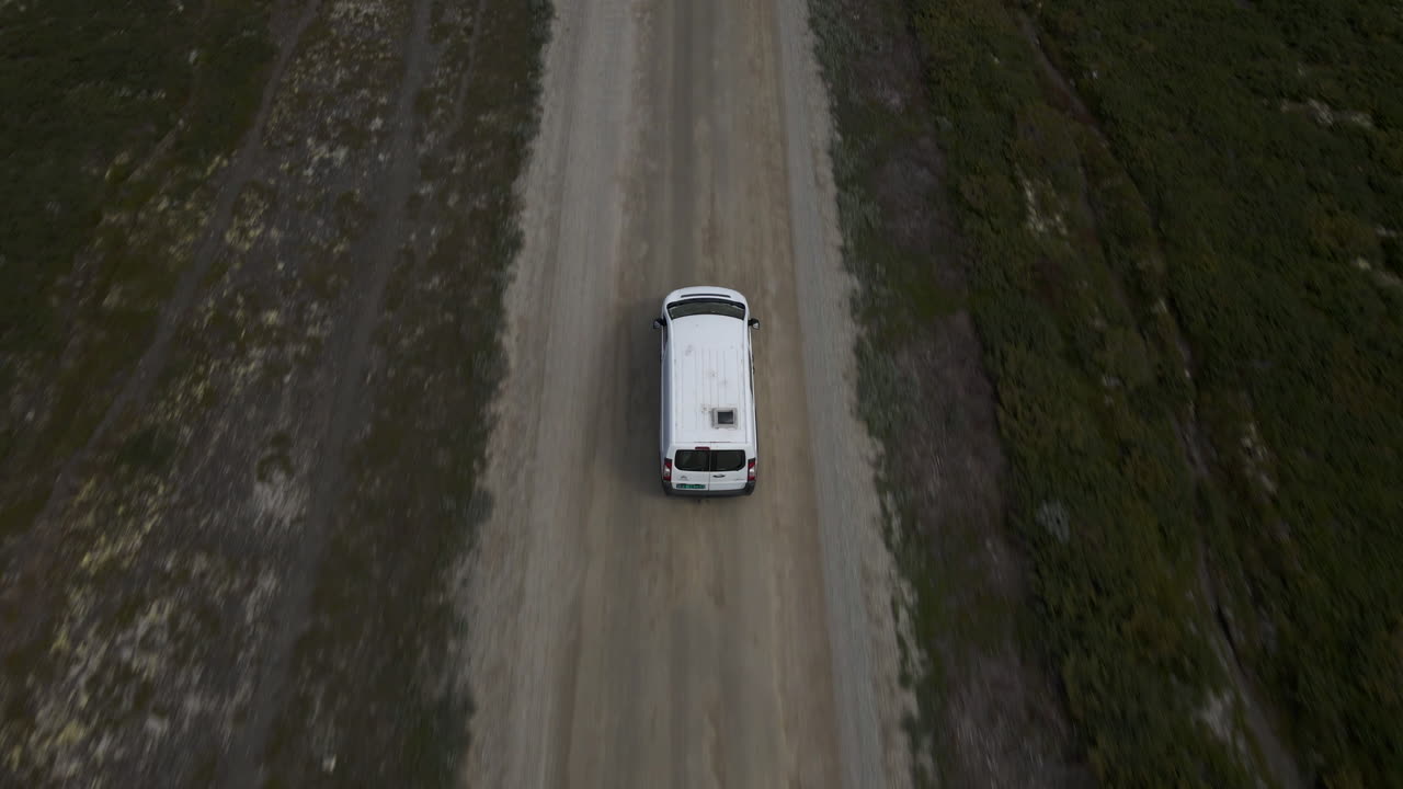 Top aerial shot of van moving in the street of Norway